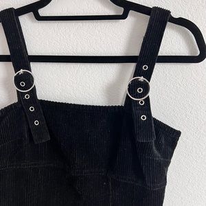 A super cute black denim dress with adjustable straps.